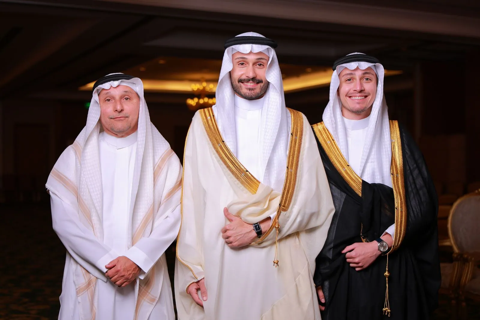 Three men in traditional thobes